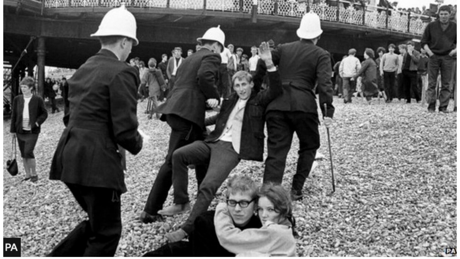 Police officers controlling a crowd on Brighton beach