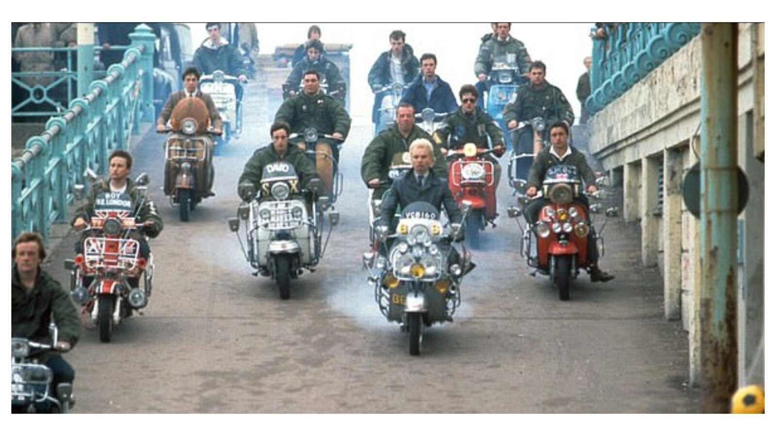 Mods riding scooters through a town street