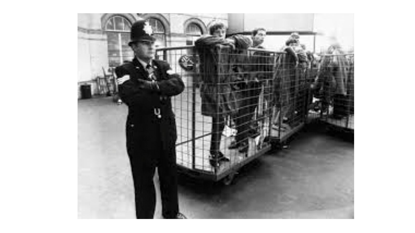 A crowd being escorted towards Brighton railway station