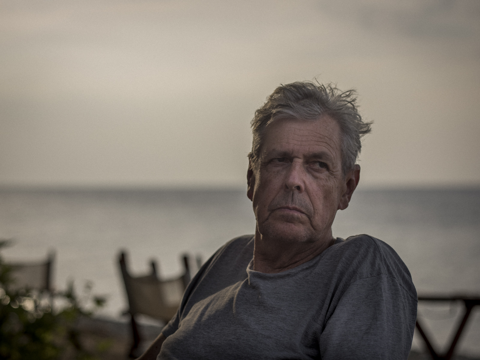 Philip Morgan seated outdoors by the sea
